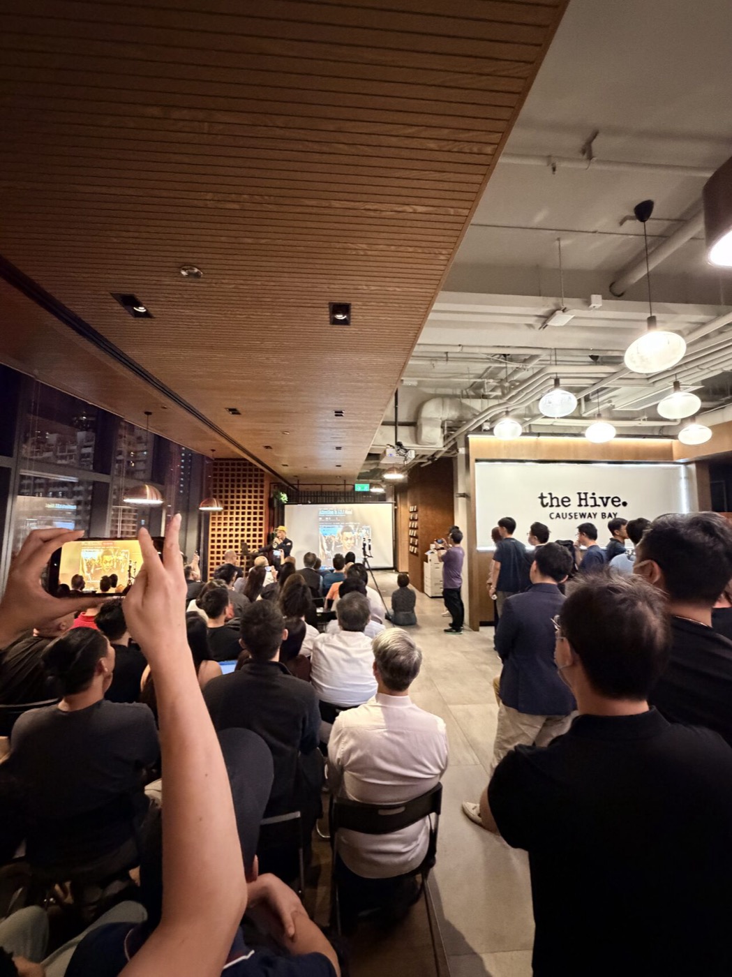 An energetic crowd with hands up