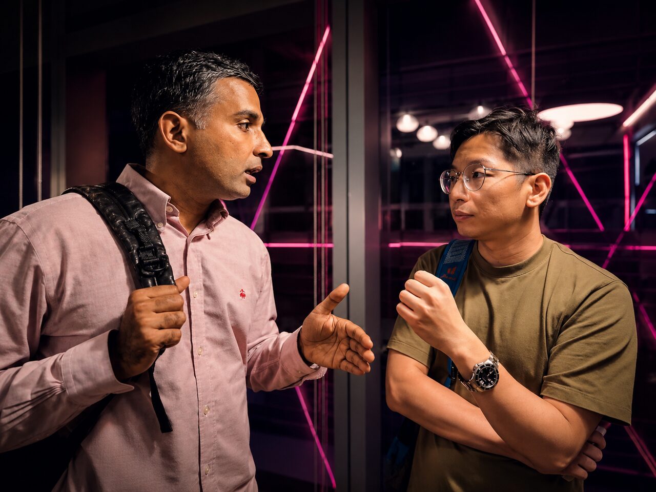 Two attendees deep in conversation under the lights
