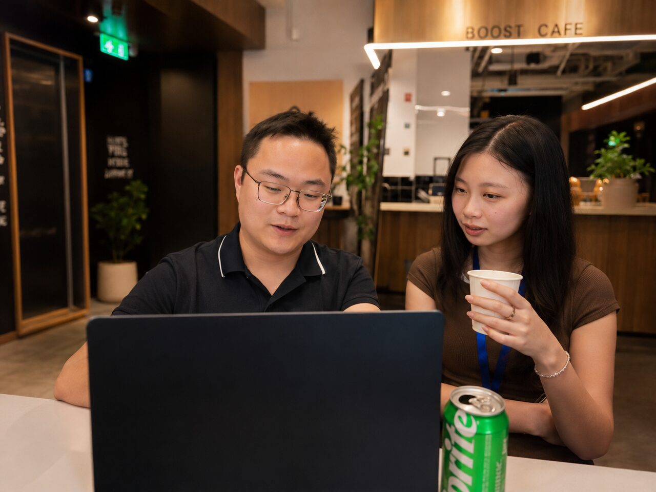 Two attendees chatting over drinks during the networking break