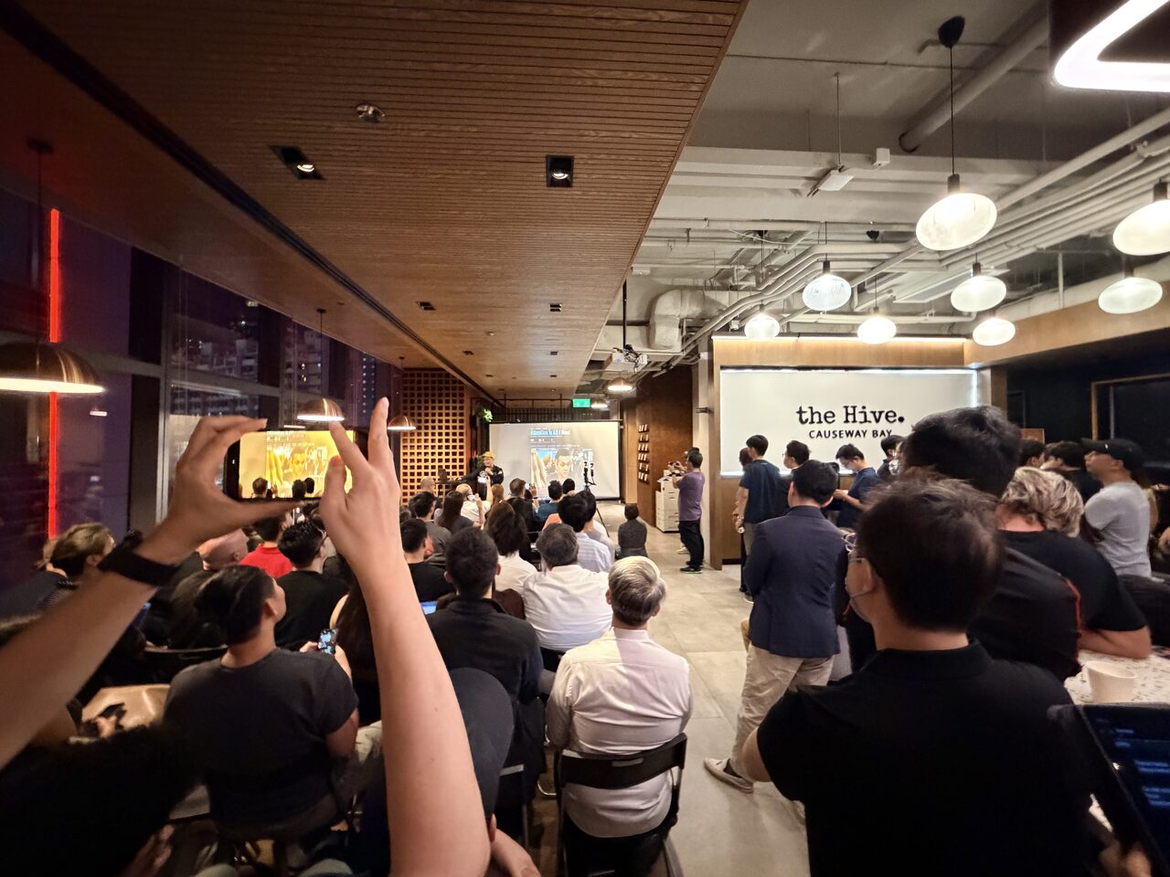The room packed wall-to-wall with attendees in the evening