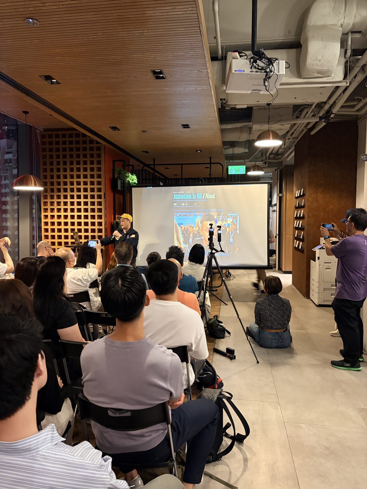 A standing-room crowd at the back of the room