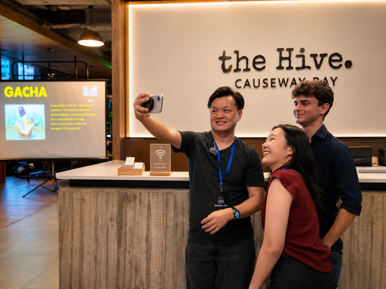 Attendees having fun in front of the the Hive Causeway Bay signage